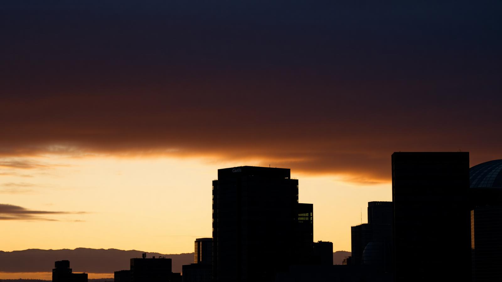 Calgary skyline at dusk with Canadian Rockies
